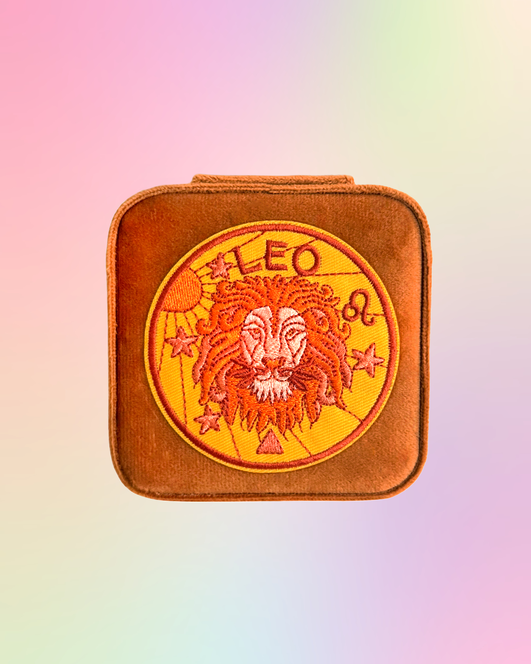 Leo zodiac sign design on a square, brown, jewelry case on a gradient background.
