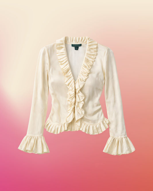 Cream silk ruffle blouse laid flat showing pleated collar, ruffled button placket, and flared cuffs.