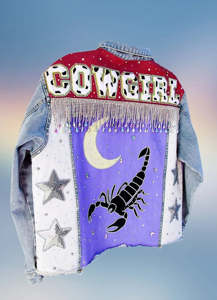 Back view of Desert Nights denim jacket featuring large scorpion artwork and moon design.