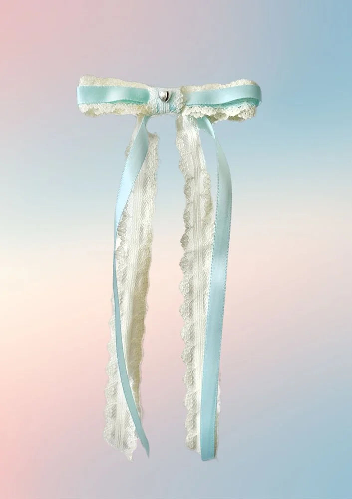 Front view of the Angel Baby hair bow with baby blue satin ribbon, white lace layers, and silver heart accent.