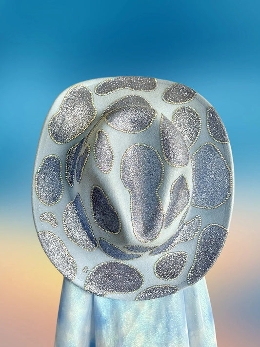 Top view of baby blue cowboy hat with sealed glitter embellishments.