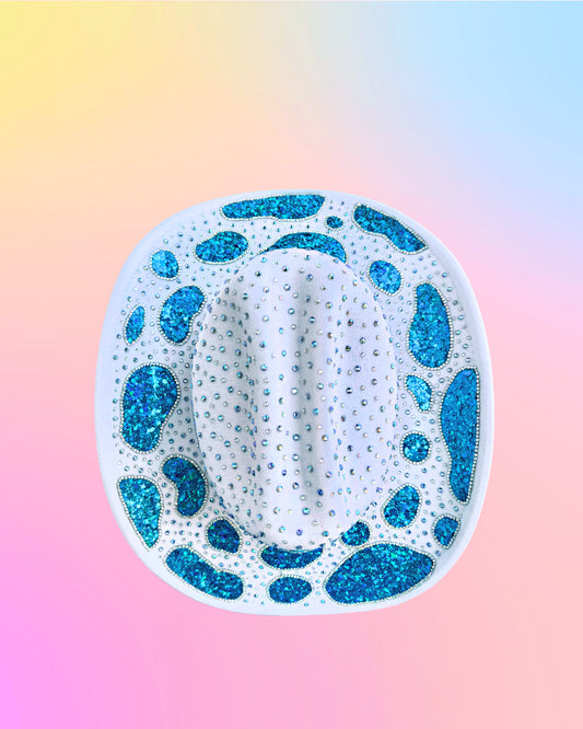 Top view of Mermaid Lagoon cowboy hat with blue glitter cow-print pattern.