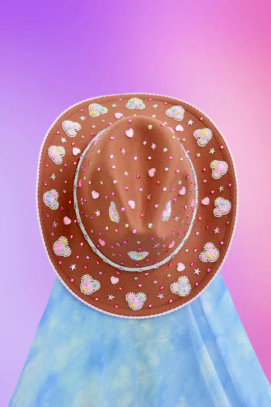 Cowboy hat with mickey mouse motif on top trim and pink glitter underside.