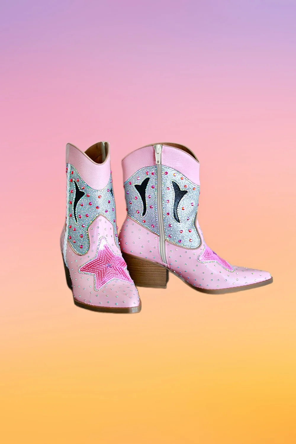 Pair of pink hand painted ankle cowboy boots with silver glitter panels and pink star embellishments.