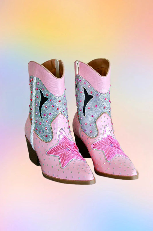 Side view of pink hand painted ankle cowboy boots with silver glitter panels rhinestones and star detailing.