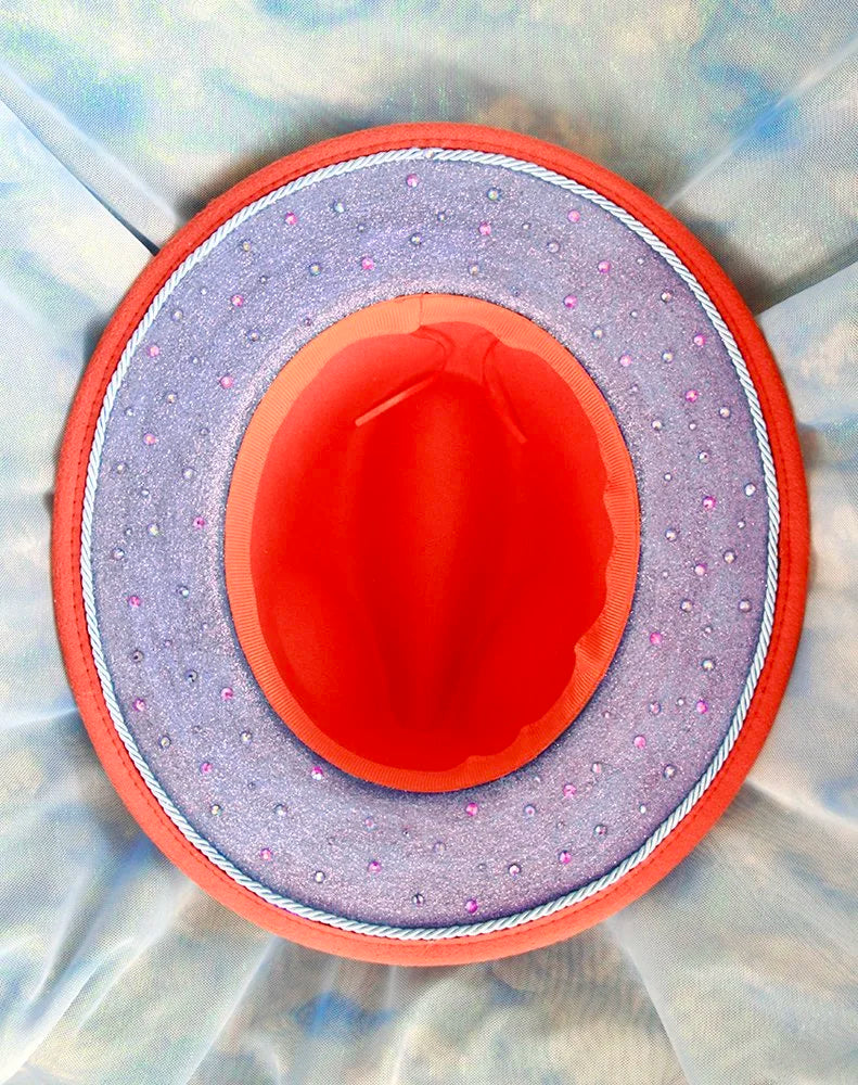 Interior view of orange fedora with blue glitter brim and scattered rhinestones.