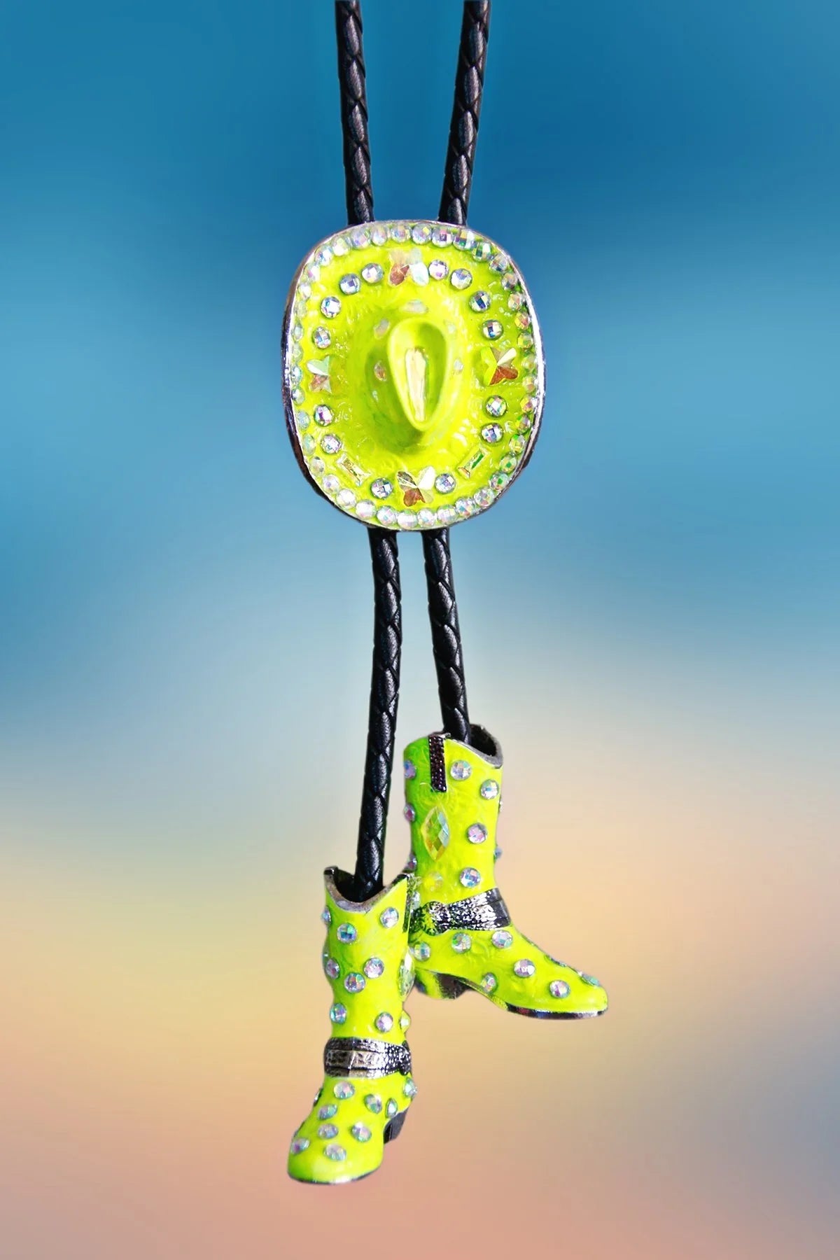 Front view of the Yellow Cowgirl Bolo Tie featuring a neon yellow cowboy hat pendant with rhinestones and matching rhinestone-studded boots.