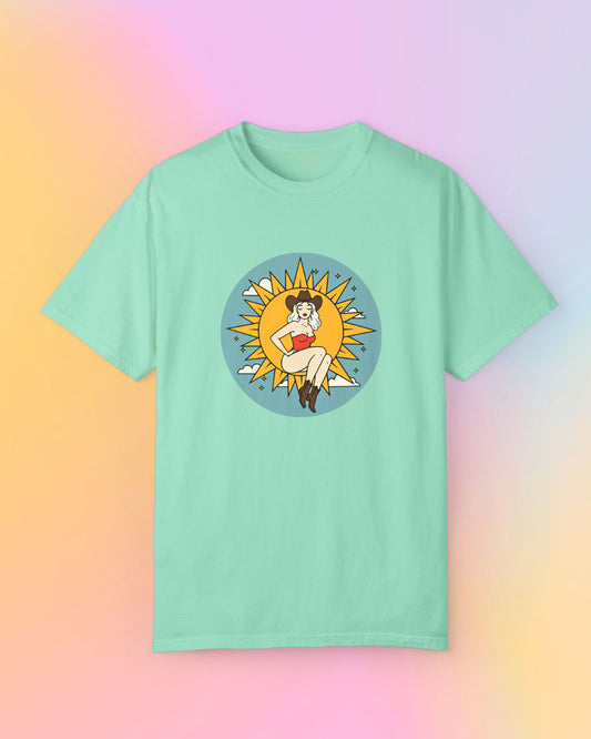 Full Moon Goddess classic t-shirt in mint green, folded flat with sun goddess western illustration on front.