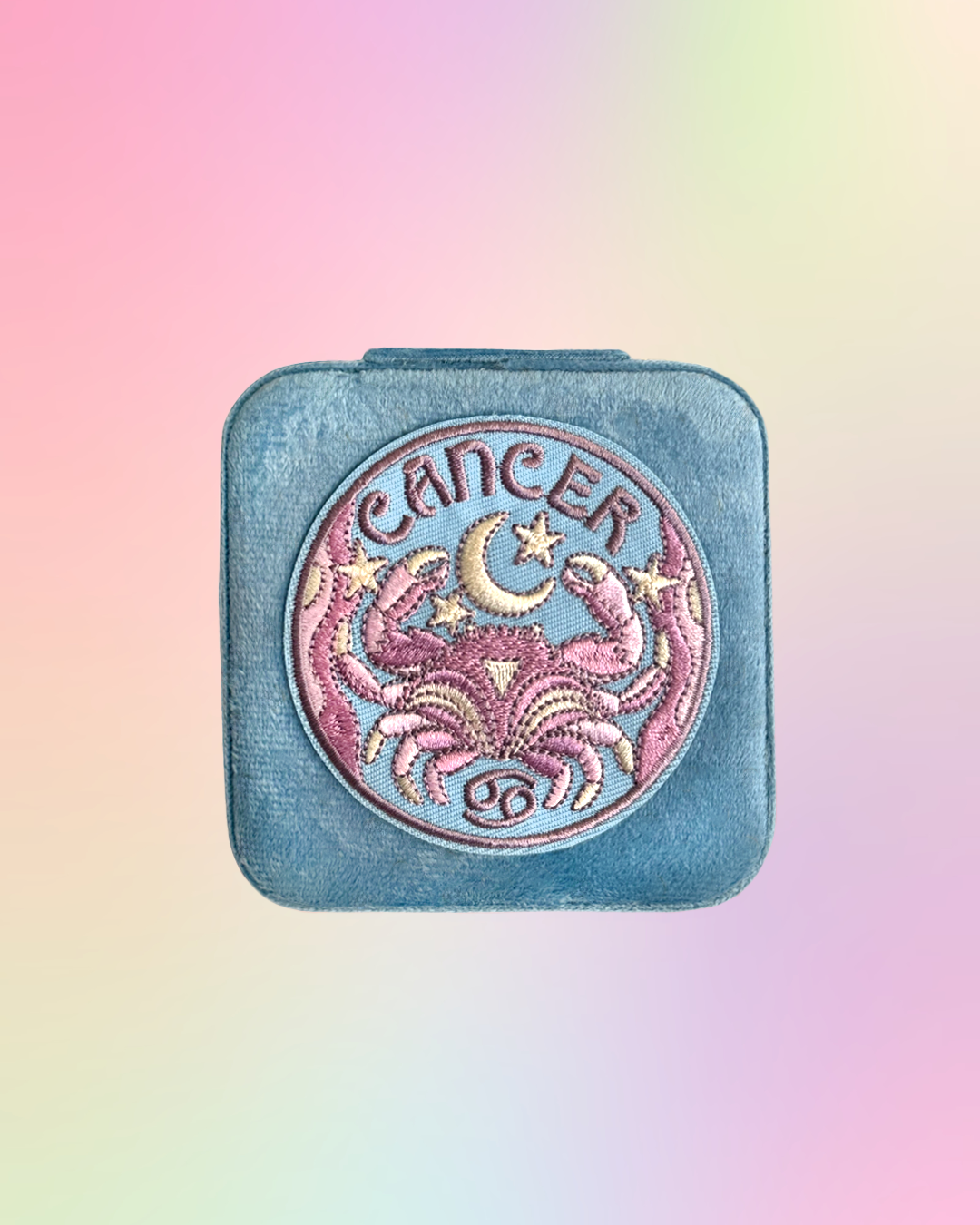 Aquarius zodiac sign design on a square, light blue, jewelry case on a gradient background.