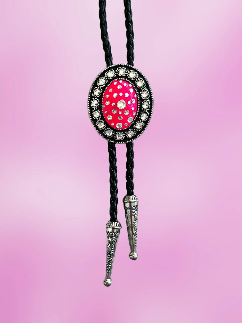 Full front view of the Blazing Rose Bolo Tie with neon pink rhinestone pendant and engraved silver tips.