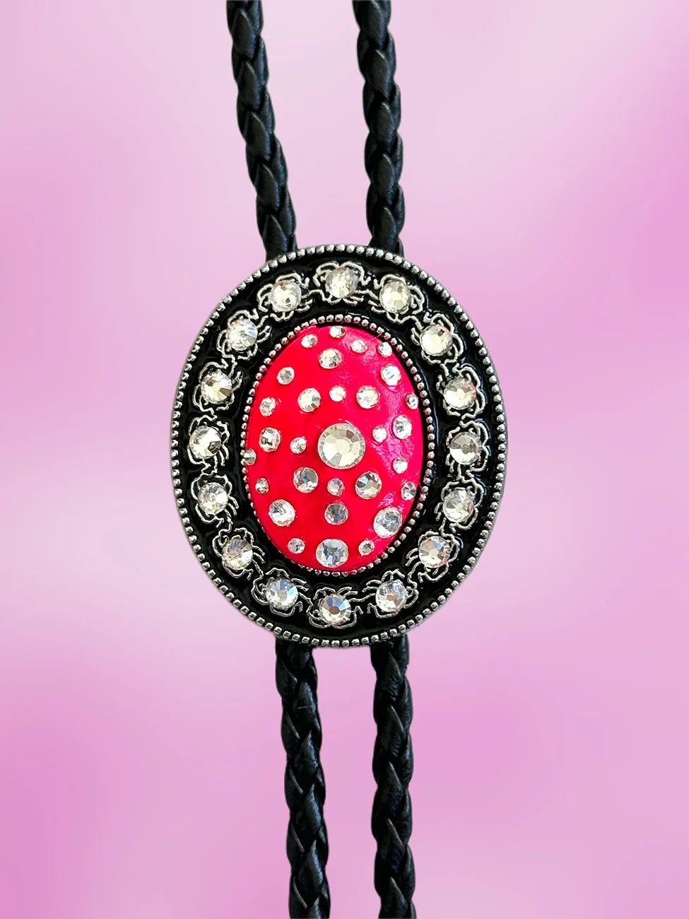Close-up of the Blazing Rose Bolo Tie pendant with neon pink paint and clear rhinestones.