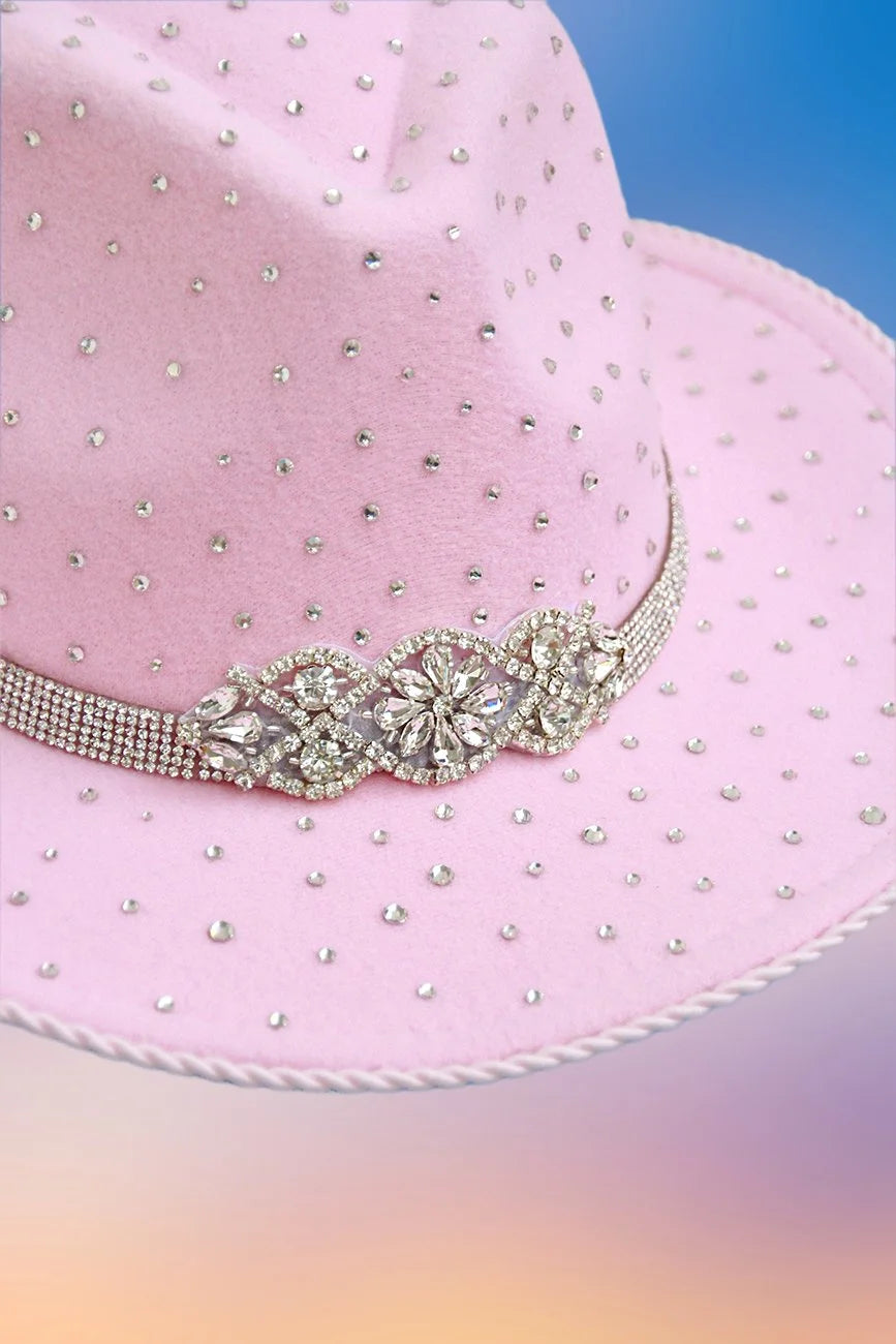 Close-up of ornate crystal centerpiece on pink rhinestone hat band.