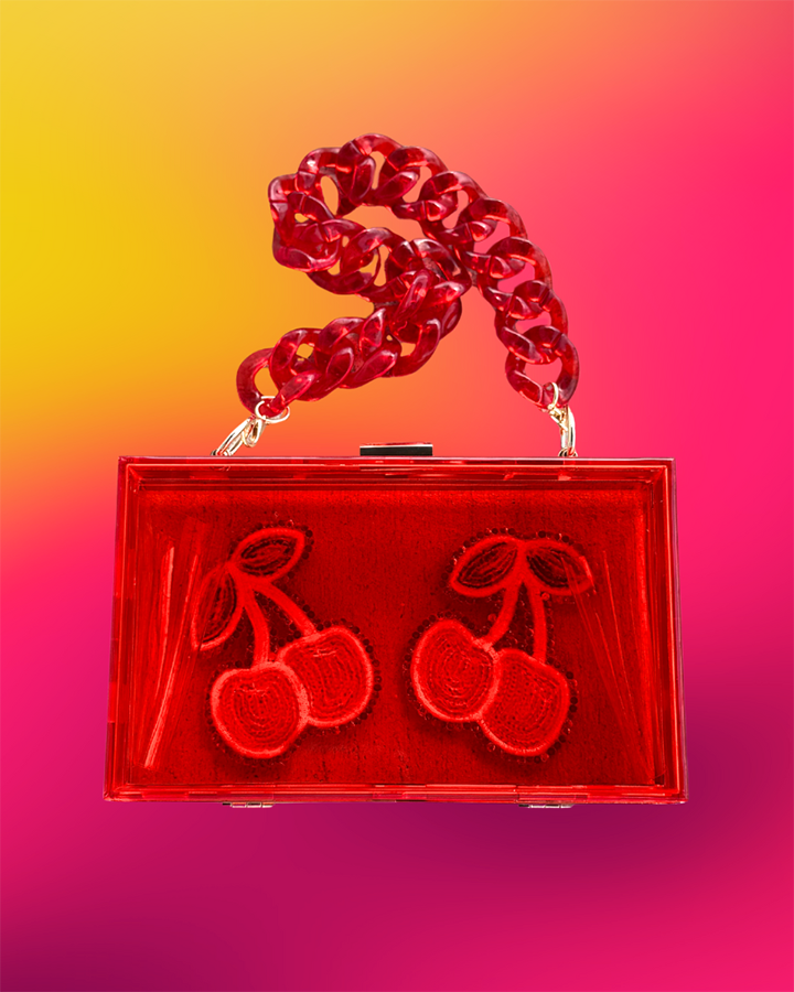 Back straight-on view of acrylic clutch featuring dual beaded cherry motifs