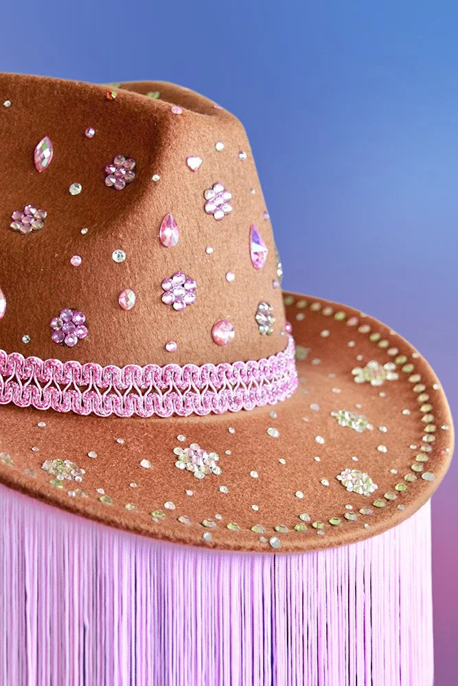 Deep camel brown cowboy hat with pink rhinestones and floral detail embellishments.