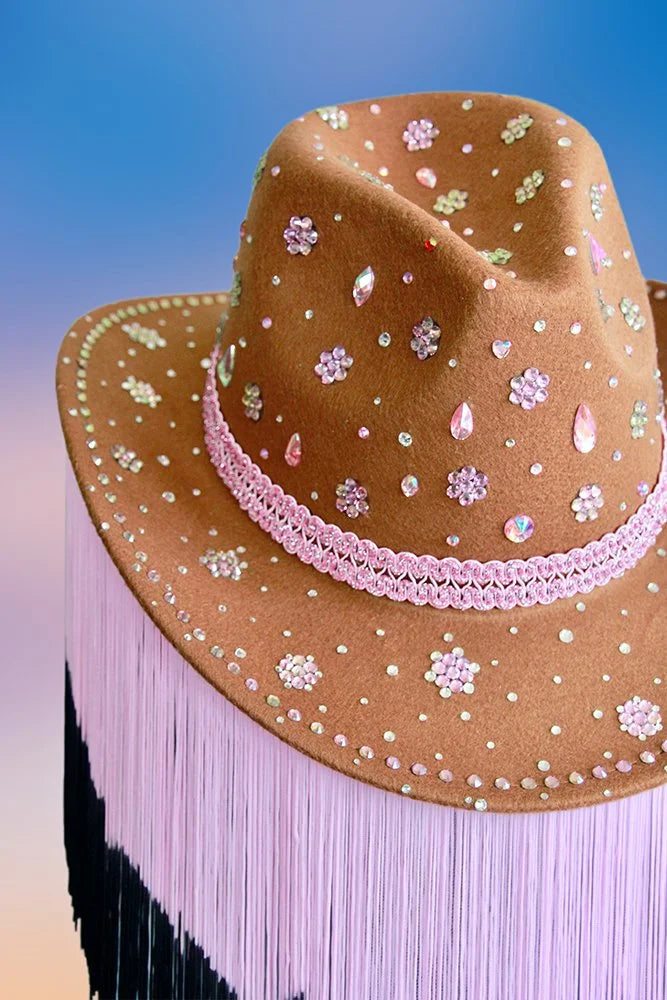 Side angle of cherry blossom cowboy hat with 8-inch pink and black fringe trim.