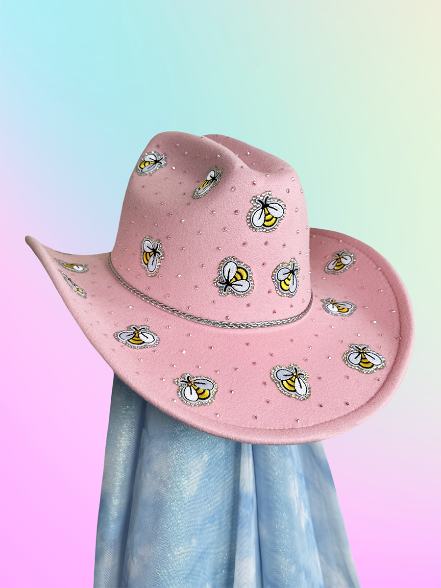 Pink cowboy hat featuring rhinestones and embroidered bee embellishments.