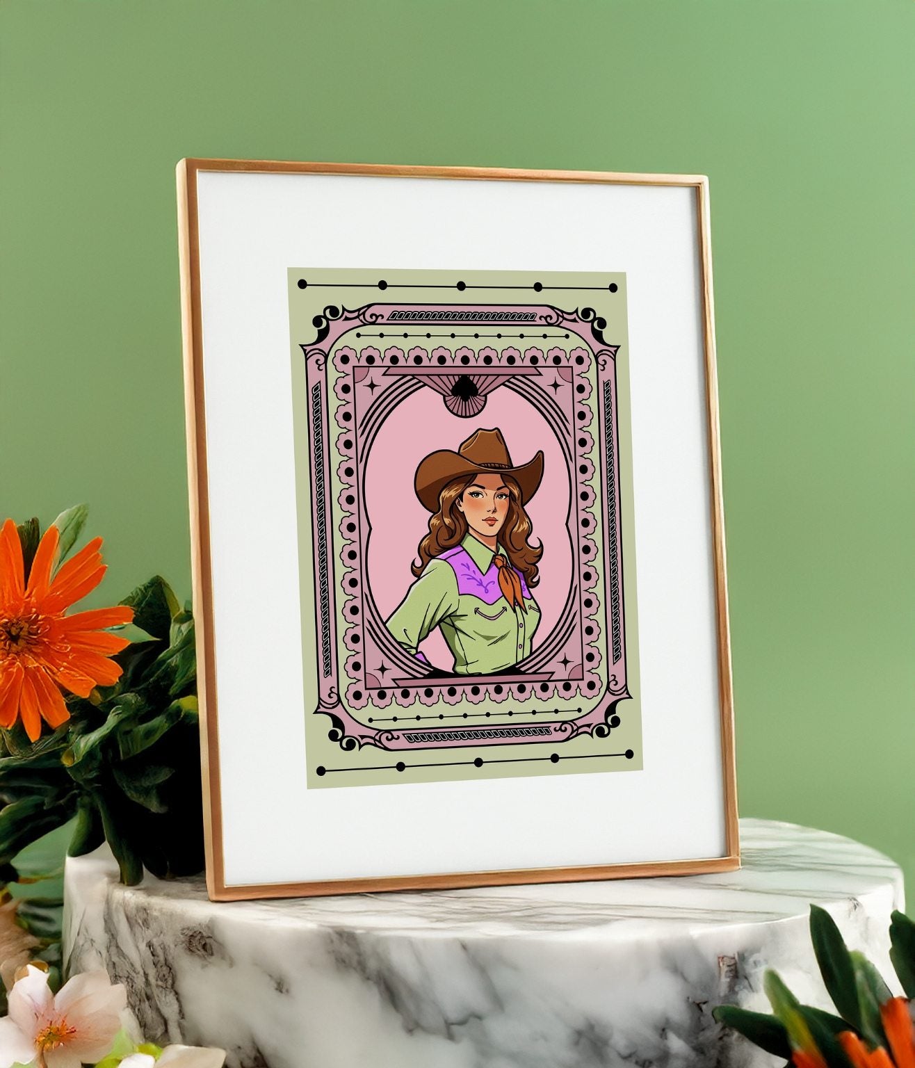 Framed cowgirl illustration with a green background styled with greenery and white marble base.