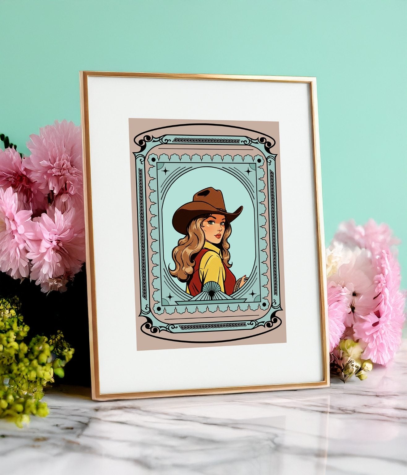 Framed cowgirl illustration with a green background styled with pink greenery and white marble base.