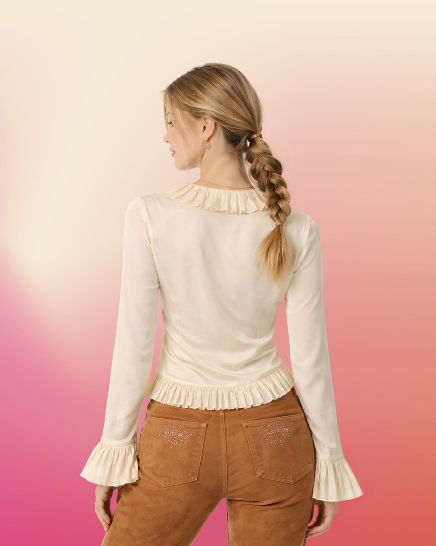 Back view of cream silk ruffle blouse showing smooth silk back, pleated collar, and ruffled hem.