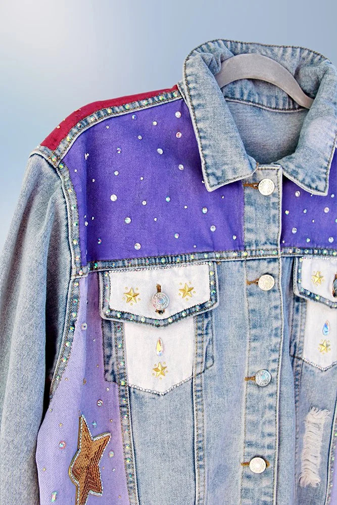 Gold and silver star embellishments on painted denim jacket.