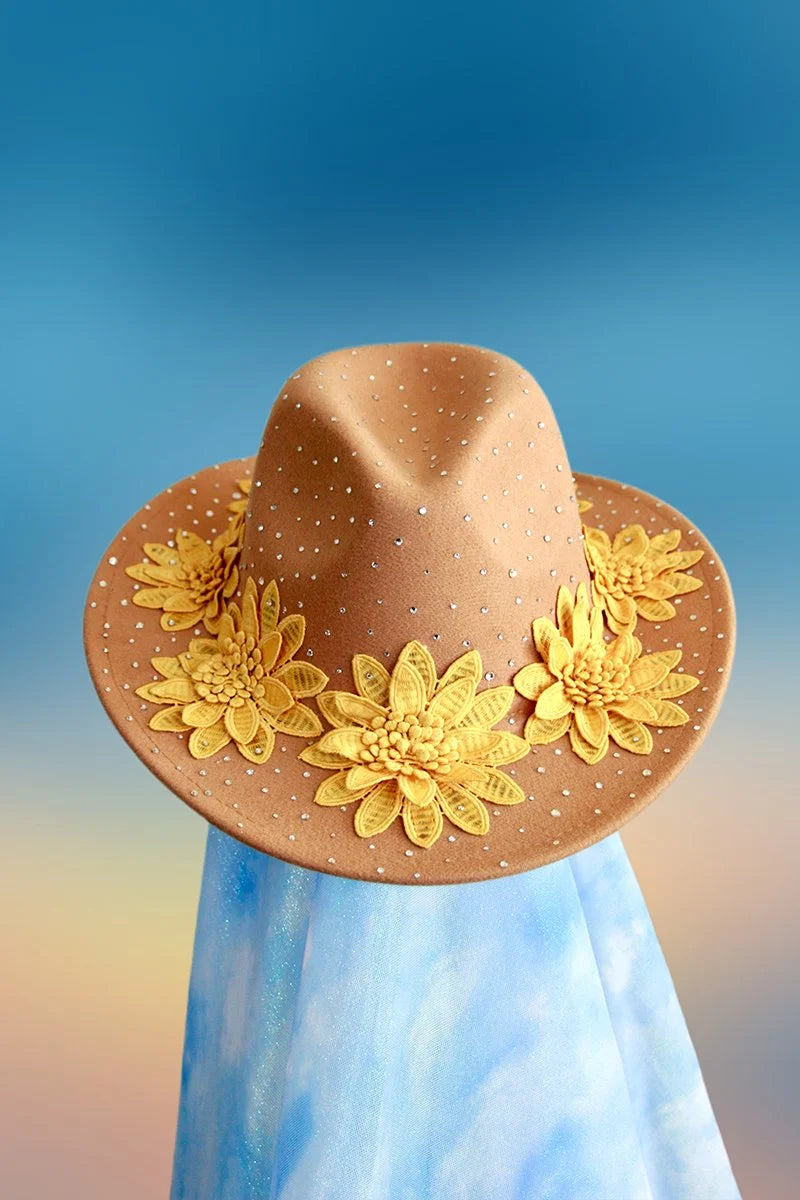 Front view of tan embellished fedora decorated with bright yellow flowers.
