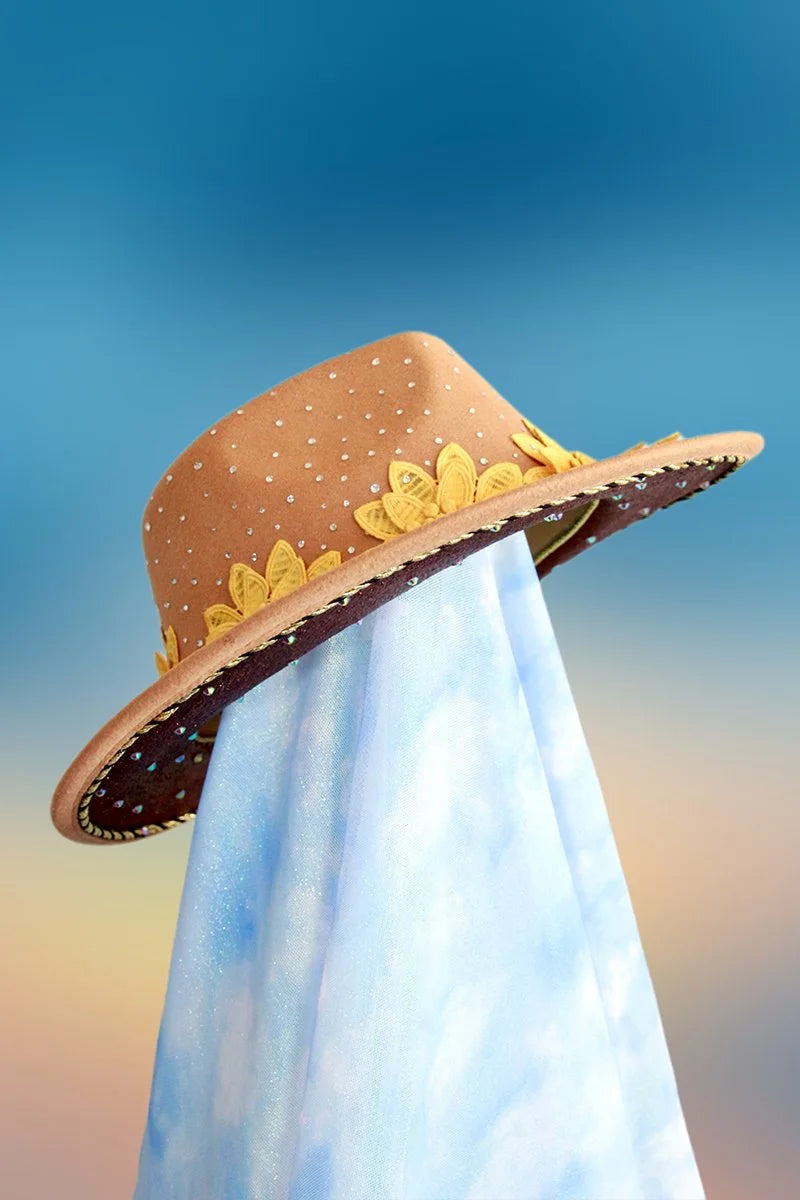 Side angle of tan fedora with bold floral appliqués around the brim.