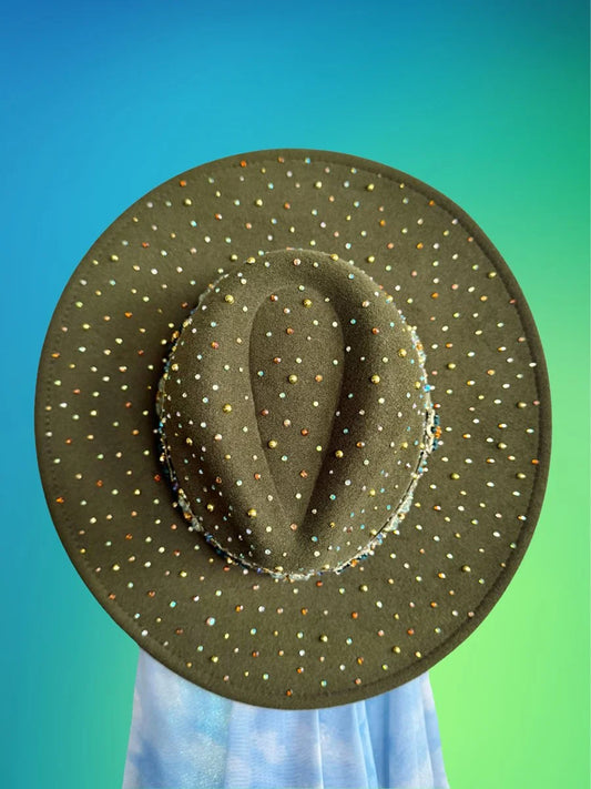 Top view of forest green fedora covered in multicolor rhinestones against gradient background.