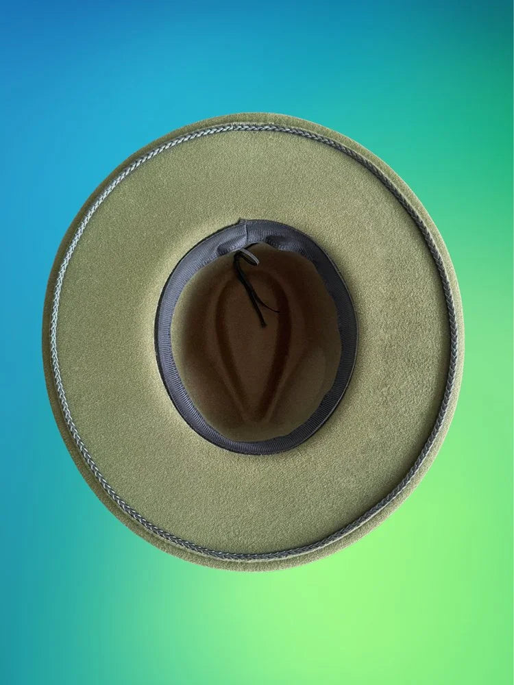 Underbrim and interior view of forest green fedora with soft gray inner band.