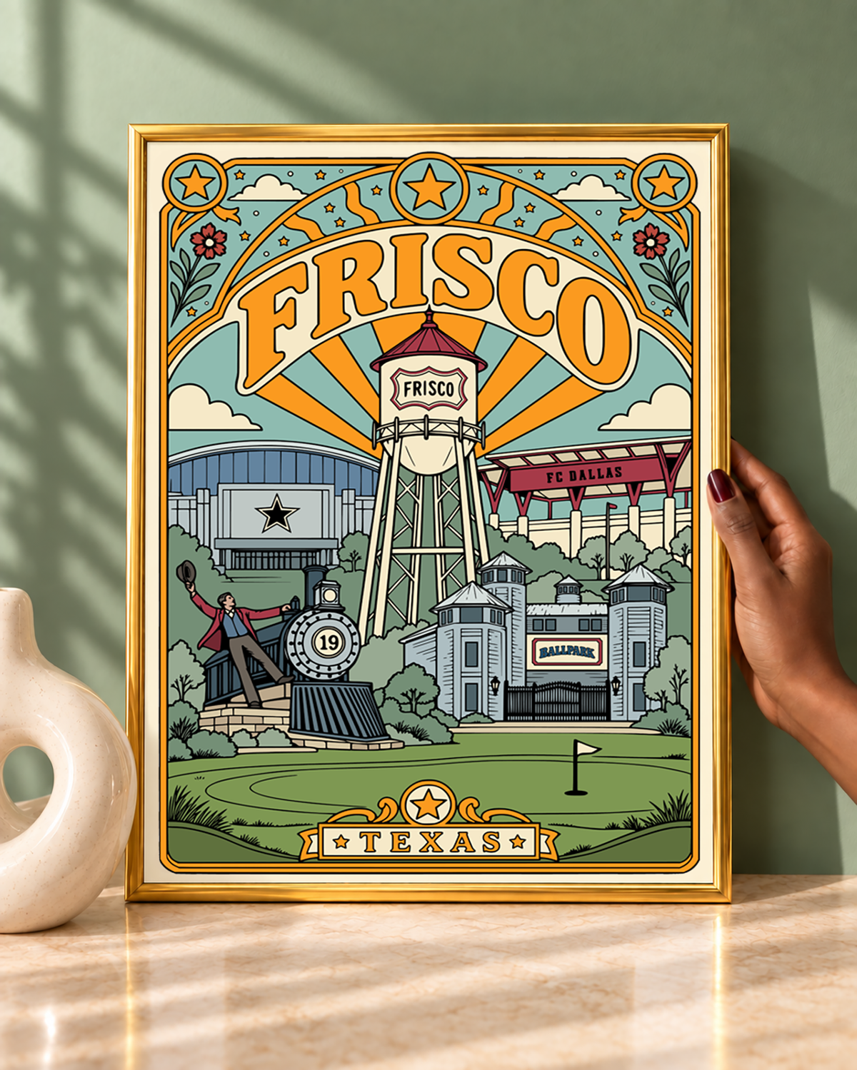 Frisco Texas wall art displayed in a modern gold frame against a sage green wall.