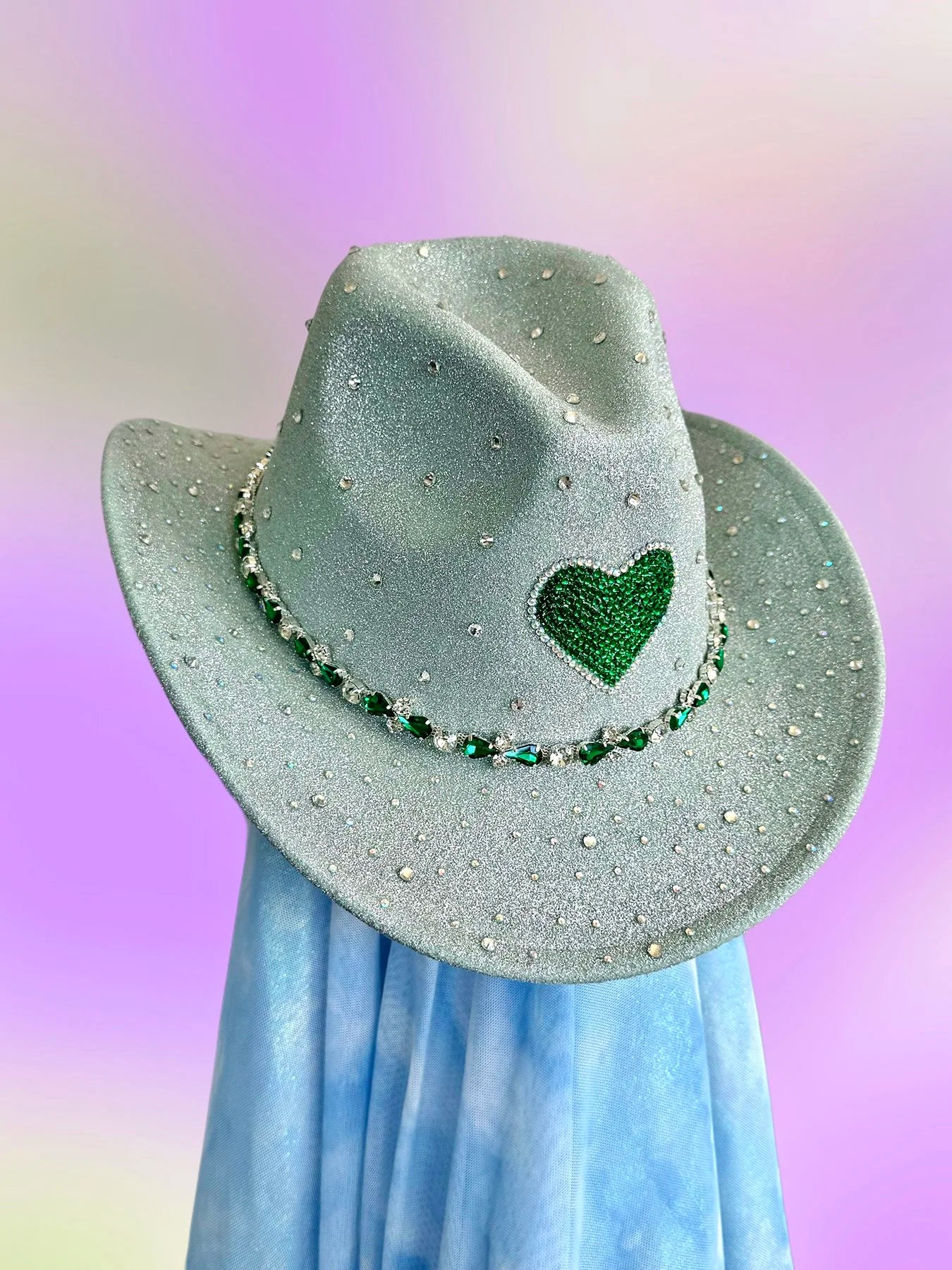 Front view of the Emerald Cowboy Hat in mint with emerald heart centerpiece, iridescent glitter, and rhinestone detailing.