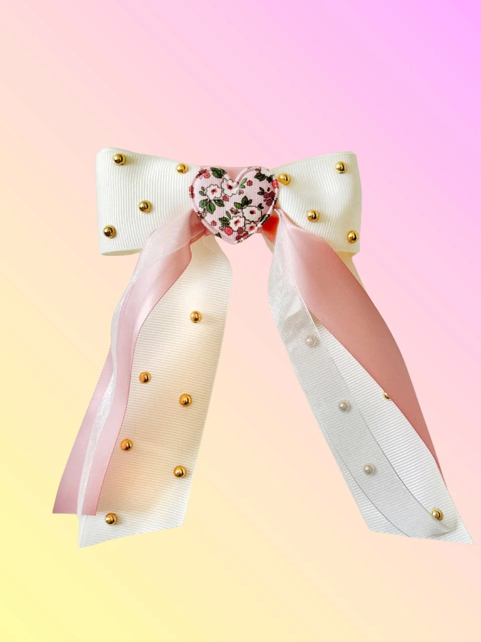 Front view of the Love Note hair bow with white ribbed ribbon, pink satin layers, soft floral heart, and gold rhinestones.