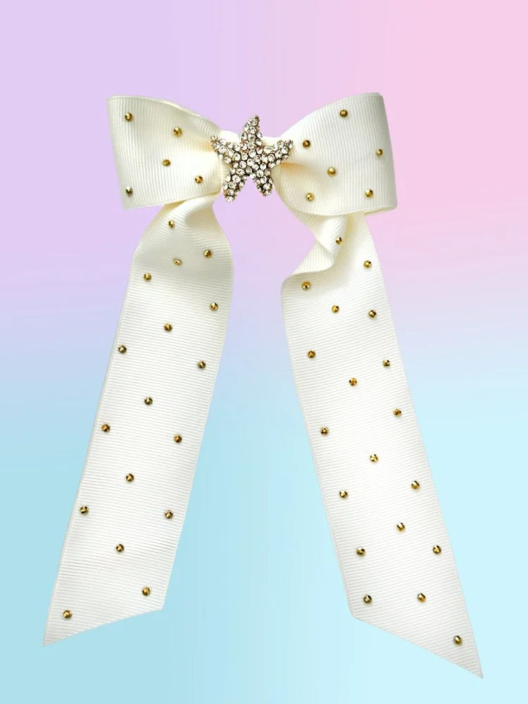 Front view of the large Ocean Darling hair bow with creamy white ribbed ribbon, gold sea star brooch, and rhinestone accents.