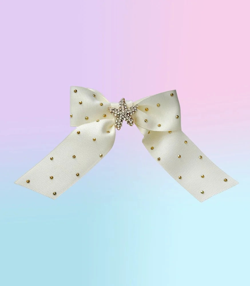 Front view of the small Ocean Darling hair bow with creamy white ribbed ribbon, gold sea star brooch, and rhinestone accents.