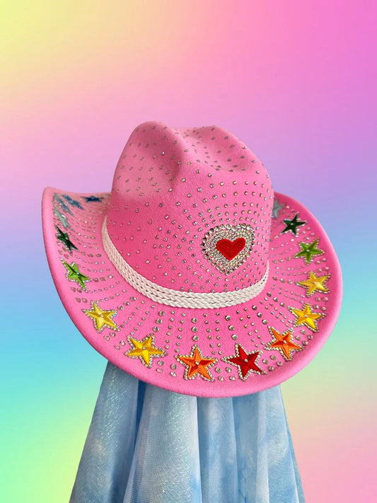 Front view of the Rainbow Rodeo cowboy hat in bubblegum pink with red heart centerpiece and rainbow star detailing.