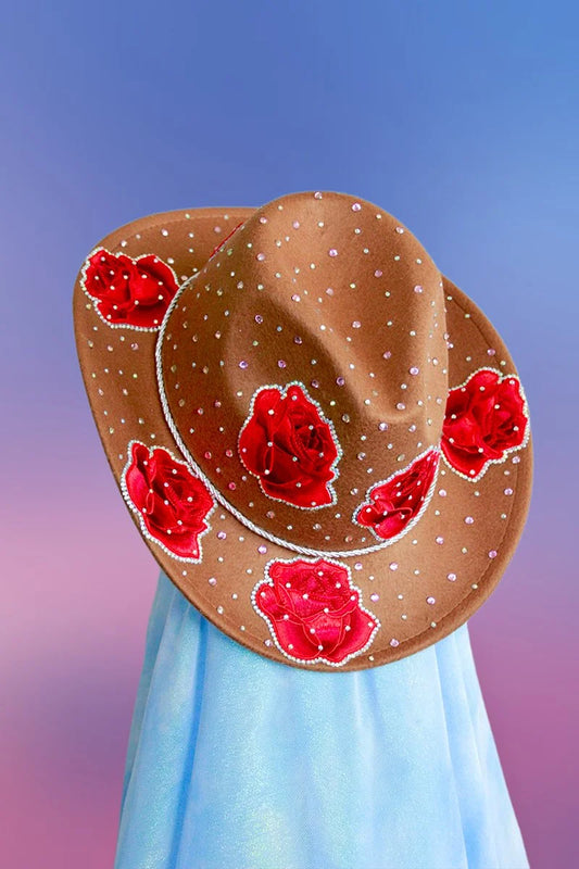 Front view of the Rose Queen cowboy hat in dark camel with rose rhinestones, silver trim, and pink glitter accents.
