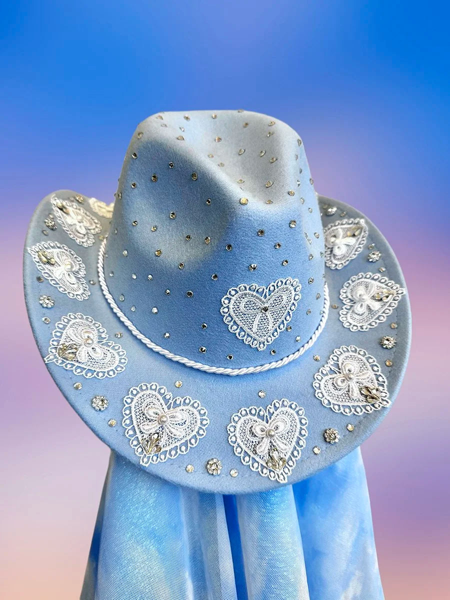 Front view of the Something Blue cowboy hat in baby blue with lace heart motifs, silver rhinestones, and glitter detailing.