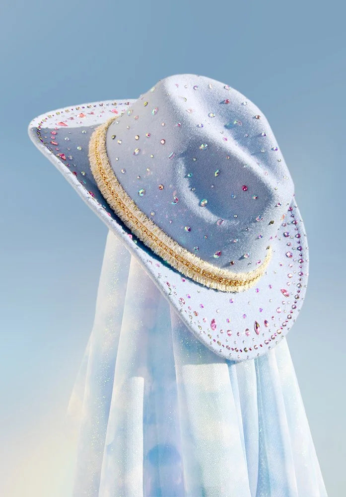 Front view of the Storyteller cowboy hat with colorful gems, fringe hat band, gold trim, and glitter underside.