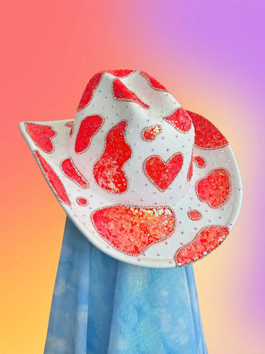 Front view of the Sugar Rush cowboy hat in white with neon pink glitter and rhinestone heart motif.
