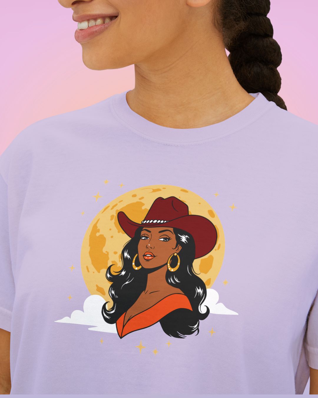Close-up of Full Moon Goddess cowgirl illustration printed on a cropped tee, featuring a western hat, golden moon, and vintage-inspired colors.