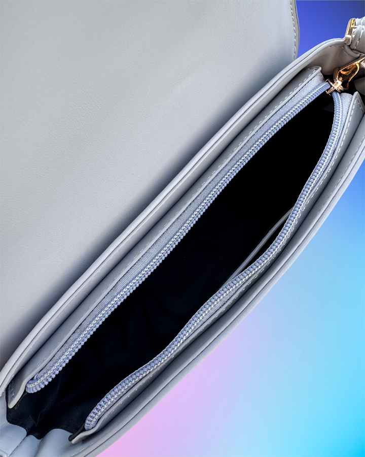Close up of interior zipper pocket inside the grey handbag.