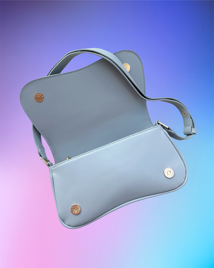 Interior view showing flap open and zipper compartment inside the grey handbag.