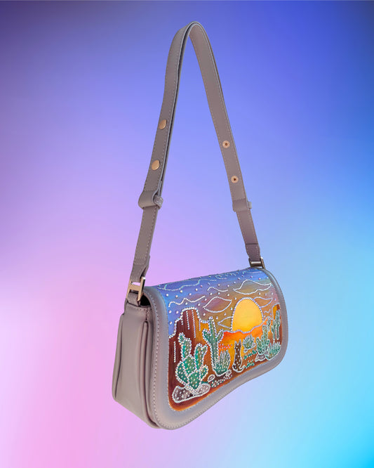 Angled side view showing painted cactus landscape and shimmering rhinestones.