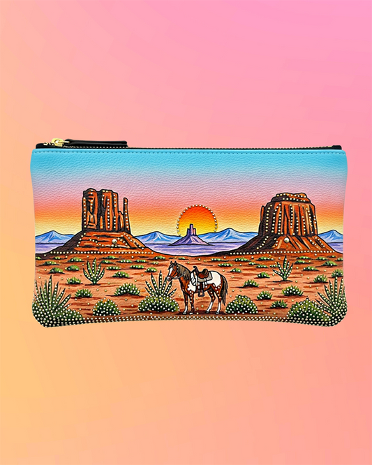 Front view of black wristlet with hand-painted desert scene and horse artwork.