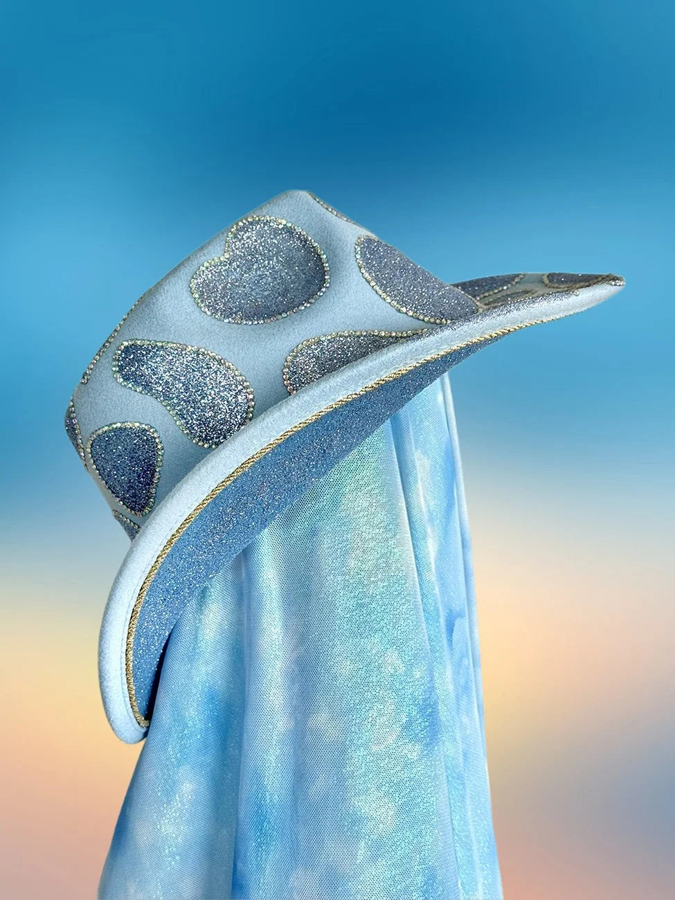Baby blue glitter cowboy hat with gold trim, side angle.