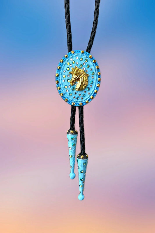 Front view of the Horse Head Bolo Tie with sky-blue pendant, gold horse centerpiece, and painted blue drop tips.