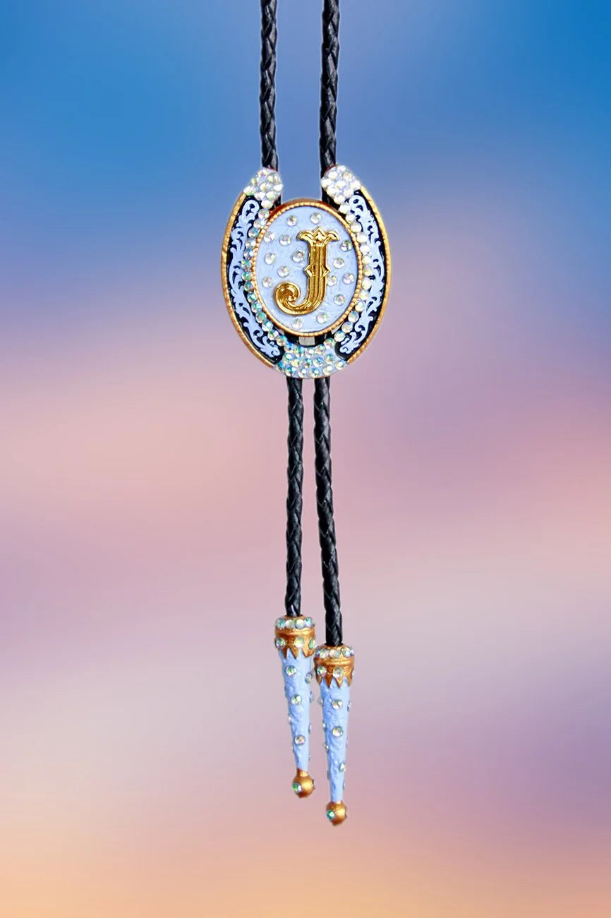 Full front view of the Horseshoe “J” bolo tie showing pendant and painted metal tips.