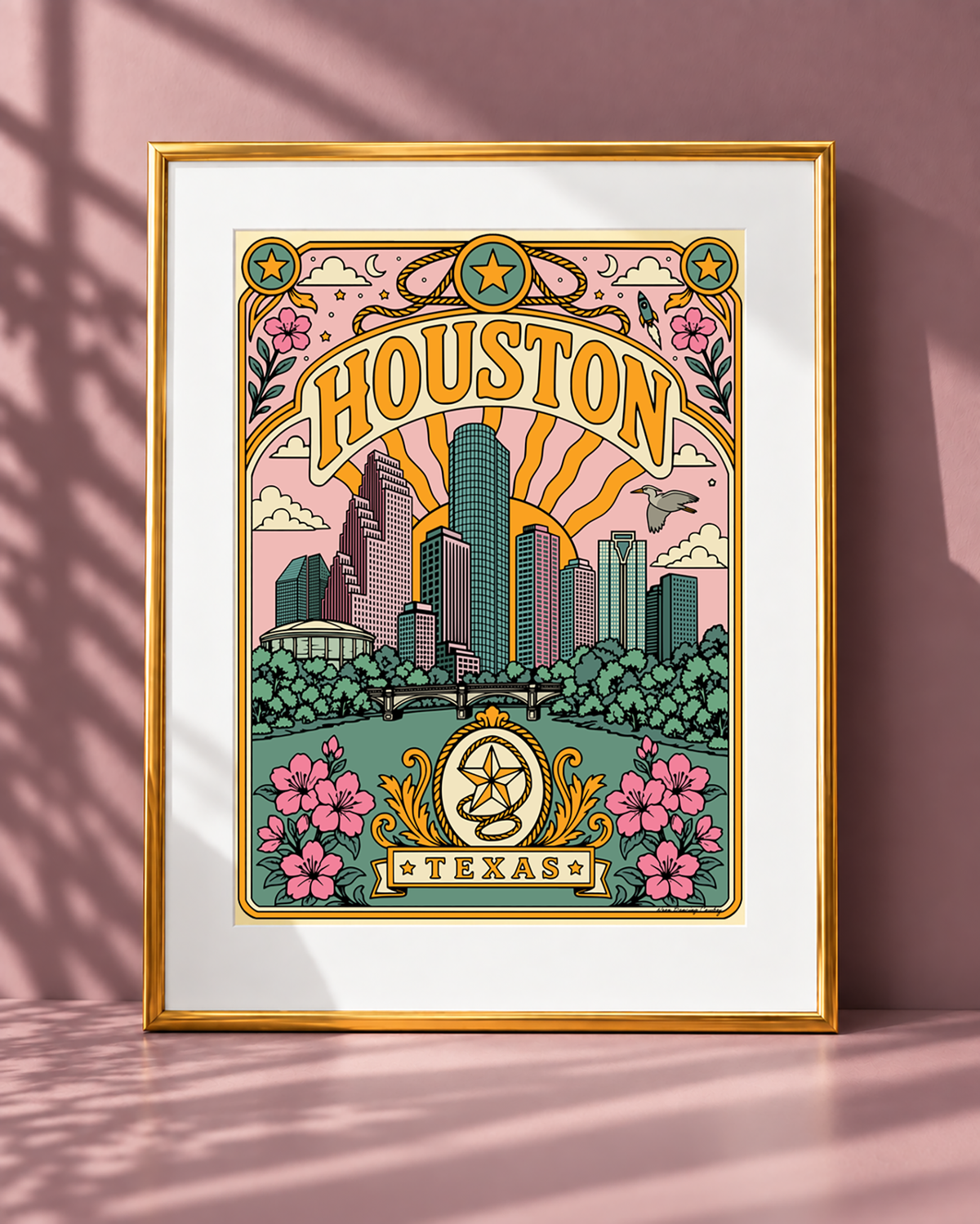 Houston Texas art print displayed with a white mat in a modern gold frame on a mauve backdrop.