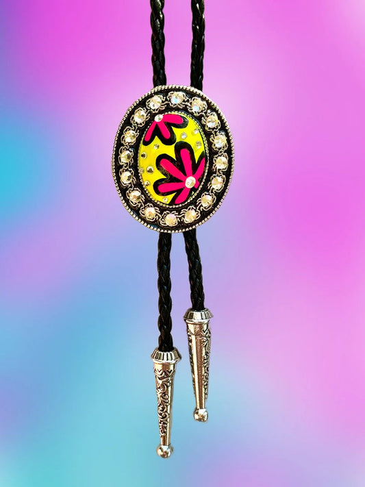 Full front view of the Jellyfish Jam Bolo Tie with a yellow and pink painted pendant and silver rhinestone border.