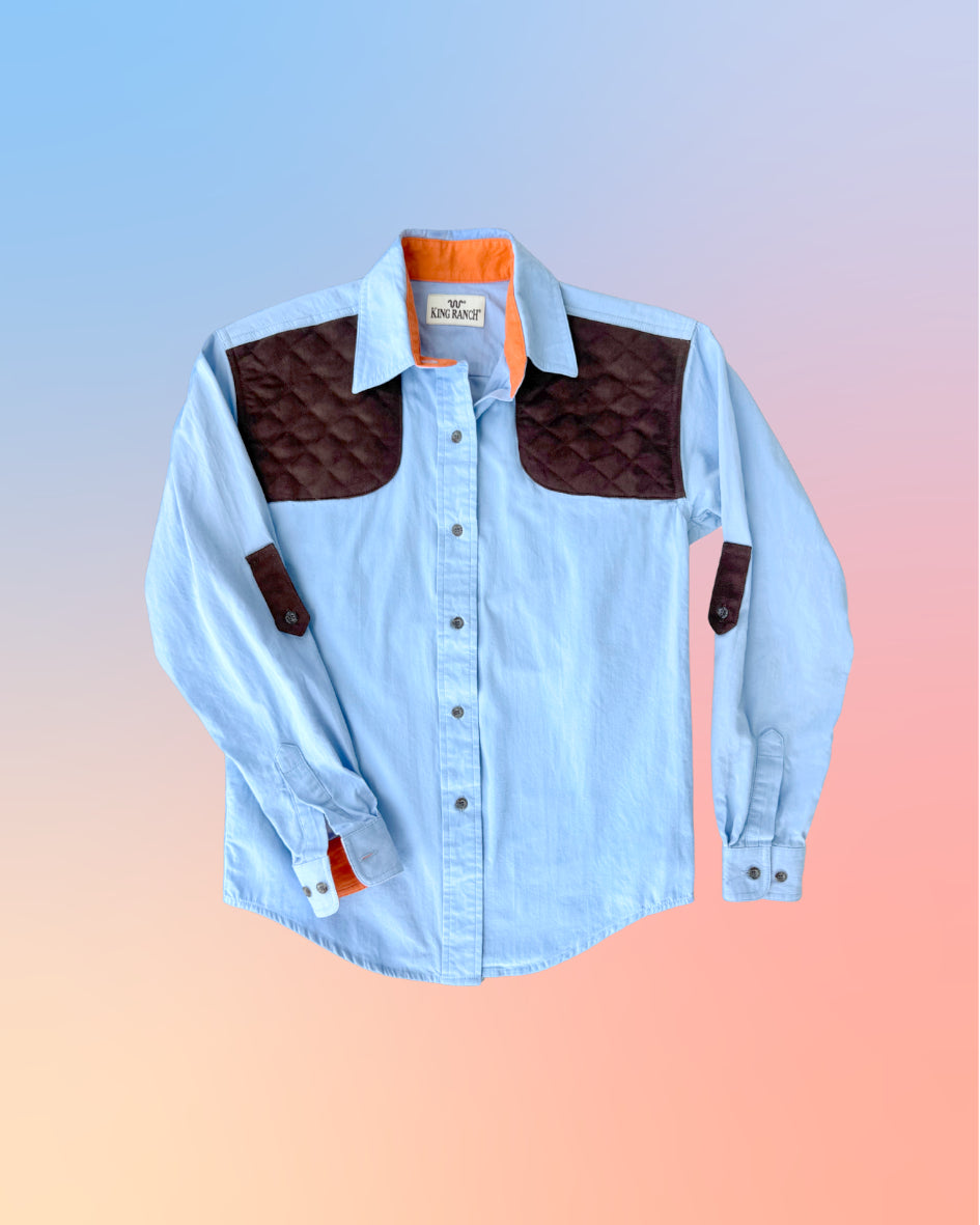 Detailed close-up of the King Ranch shirt’s orange cuff lining and metal button accents.