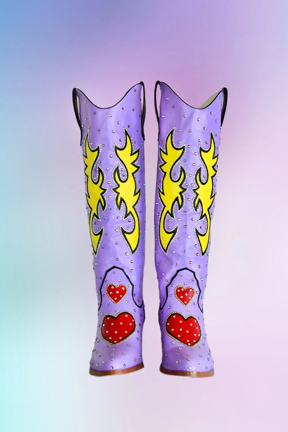 Lavender cowboy boots front angle showing flame design and rhinestones.